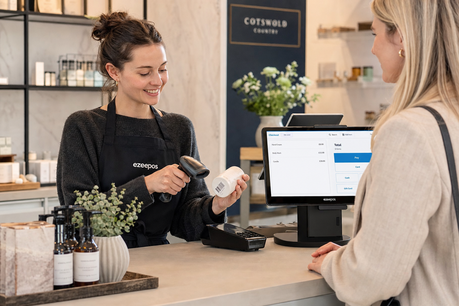 Barcode Scanning for Faster Retail Checkouts, photorealistic commercial photography style of a modern UK independent retail shop counter with a friendly staff member scanning a product barcode at a clean touchscreen EPOS till, a small barcode scanner in use, neatly arranged products on the counter, a customer waiting comfortably, subtle blue interface accents on the POS screen, warm natural lighting, shallow depth of field, premium but realistic composition, professional blog hero image for ezeepos, focused on faster checkout service and efficient retail workflow, clean counter area, authentic British retail environment, no clutter, no cartoon style, no abstract background, no exaggerated futuristic devices
