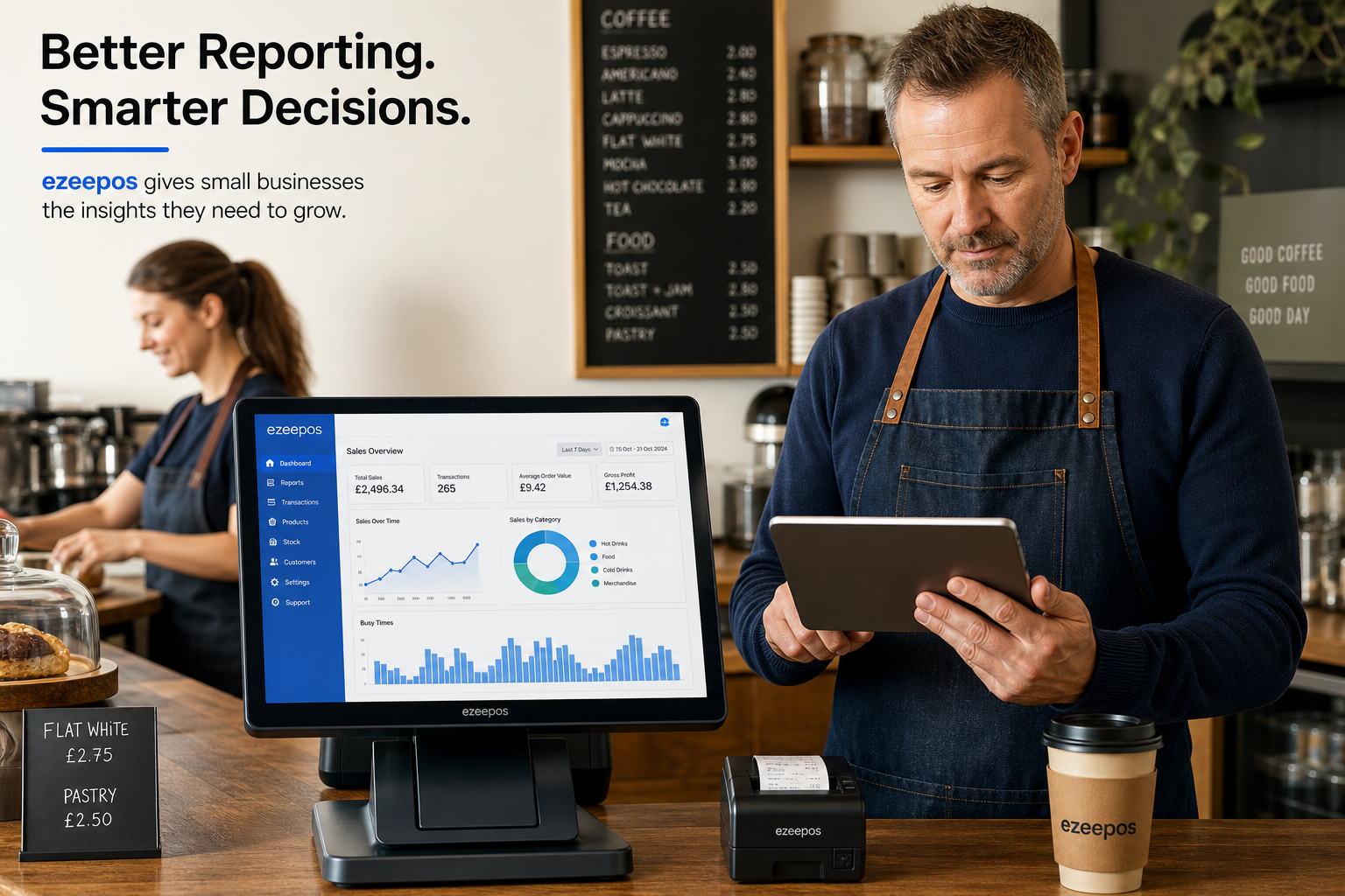 How Better Reporting Helps Small Businesses Make Smarter Decisions: photorealistic commercial photography style image showing a UK independent cafÃ© owner standing beside a clean modern touchscreen EPOS terminal and tablet, reviewing sales dashboard charts and busy-time graphs during a calm moment in service, with a friendly staff member in the background and subtle blue brand accents on the screen interface, warm natural lighting, shallow depth of field, realistic counter area with receipts and a takeaway coffee cup, professional modern British business environment, premium but believable composition designed as a WordPress featured image for ezeepos, with the reporting screen clearly visible and the technology as the focus.