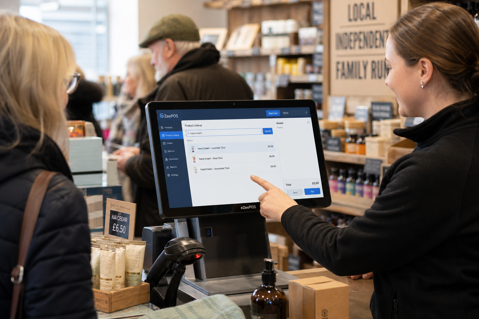 Why Product Lookup Makes Busy Retail Checkouts Easier - Photorealistic commercial photography style image for a UK independent retail shop counter during a busy trading period, showing a friendly staff member using a modern eZeePOS-style touchscreen till to quickly search for a product lookup item while serving a customer, with a clean counter area, barcode scanner, product shelves, and a subtle blue-accented POS interface visible on screen; the scene should feel warm, professional and realistic, with natural lighting, shallow depth of field, premium but practical composition, and clear focus on how product lookup helps staff keep queues moving and find items fast in a real retail environment, suitable as a WordPress featured image for an ezeepos blog post.